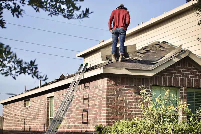 Professional roofer working on a residential roof in Laplace